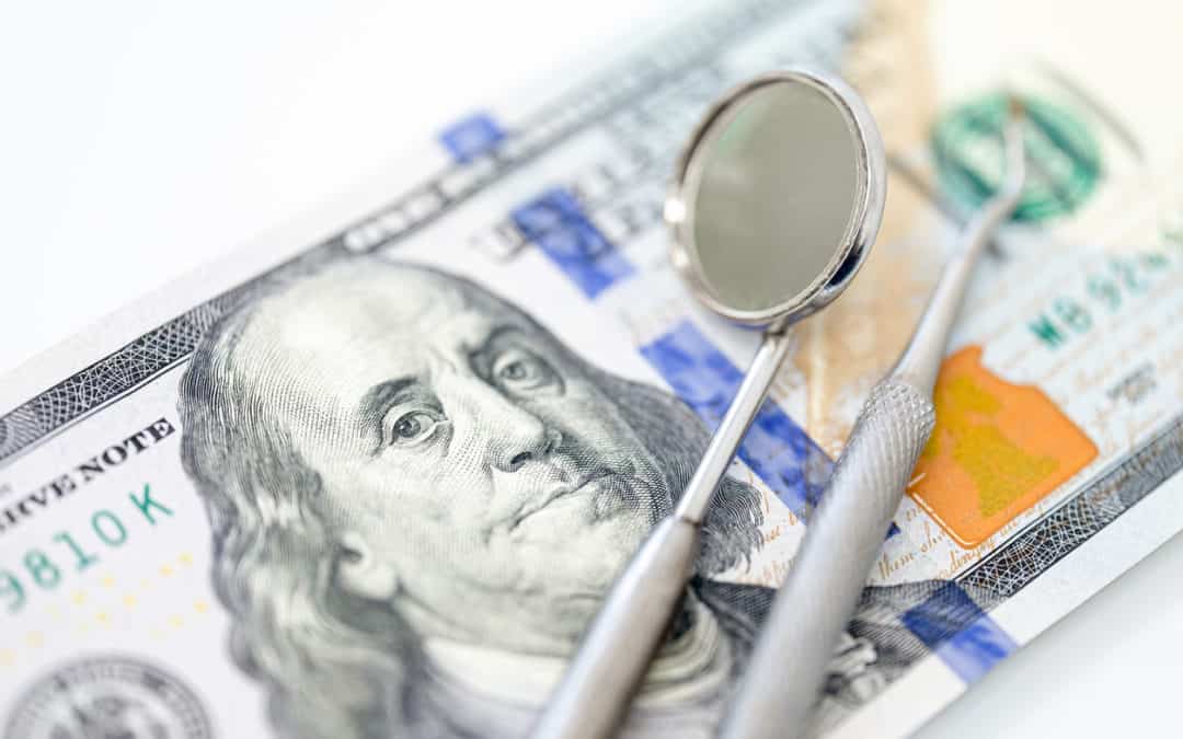 Dental tools on a hundred dollar bill. The concept of health insurance, profitable business
